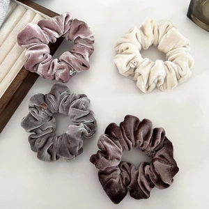 Set of four velvet scrunchies in pastel colors with elegant silver metal charm detail