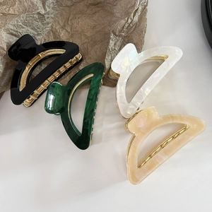 Semicircle acetate hair claws set in black, emerald, pearl white, and marble orange