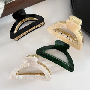 Set of four minimalist acetate hair claws with gold metal teeth in assorted elegant colors