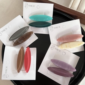 Set of minimalist candy-colored oval hair clips with elegant marble pattern for women