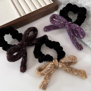 Three retro purple and brown knitted bow hair scrunchies on white background