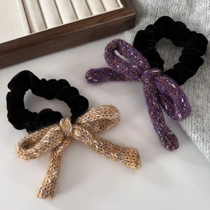 Vintage velvet hair ties with purple and brown knitted bows shown on wooden box
