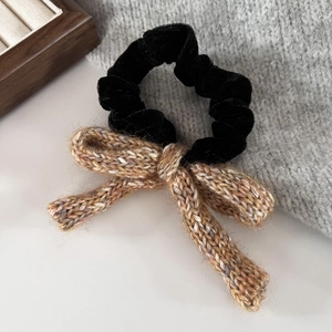 Detail of vintage purple knitted bow hair tie with premium velvet scrunchie texture