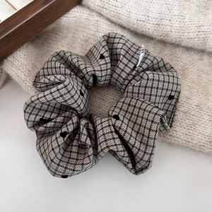 Detail of checkered hair scrunchie with polka dots and soft velvet flocking texture