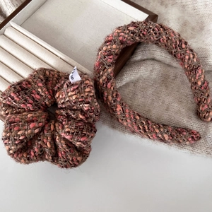 Detailed view of tweed scrunchie and headband set in brown and pink autumn style textures