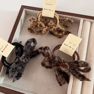 Three-piece set of leopard print bow hair ties in dark grey, brown, and light beige colors
