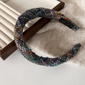 Detail of handmade thick multi-color tweed headband with premium textured fabric finish