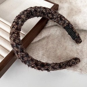 Detail of handmade brown tweed headband texture with black hand made woven label