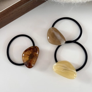 Three minimalist geometric hair ties with amber resin charms and high-elastic bands