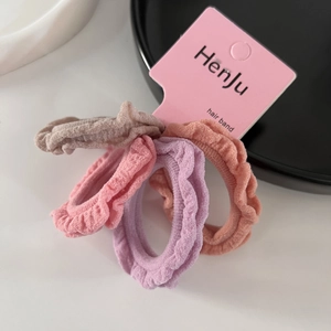 Detail of four ruffle hair ties in Morandi colors with high-elastic pleated fabric