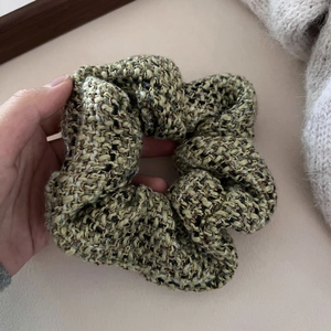 Retro tweed scrunchie with green and yellow woven fibers for elegant autumn winter hairstyling