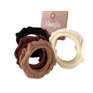 Set of 4 ruffle elastic hair ties in neutral earth tones on display card