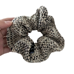 Classic tweed scrunchie in black and white weave with elegant satin label detail