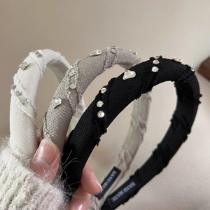 Detailed close-up of handmade fabric headbands featuring sparkling rhinestone heart accents