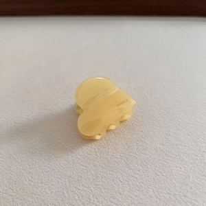 Detail of a small heart-shaped acetic acid hair claw clip with France Handmade marking