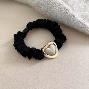 Black scrunchie with a gold heart pendant featuring a cream resin inlay for women