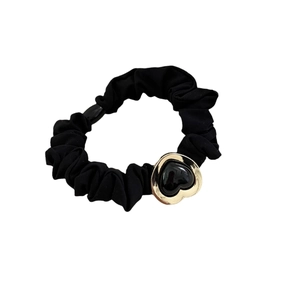 Elastic black scrunchie with a gold metal heart charm and glossy black inlay centerpiece
