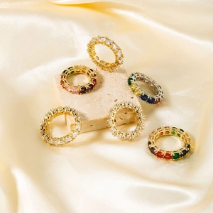Exquisite eternity rings with colorful oval zircon stones on stone and satin background