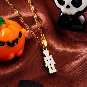 Halloween necklace with gold chain and white enamel skeleton pendant on brown silk