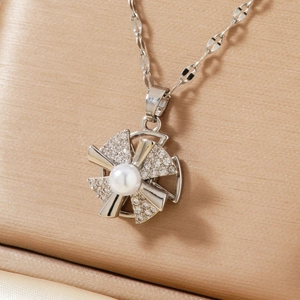 Elegant rotating windmill pendant necklace with pearl and sparkling zircons for women