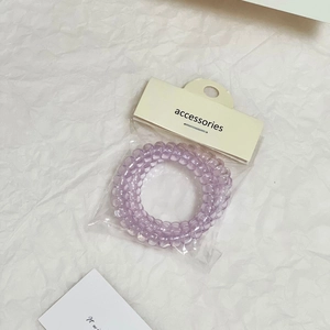Dettaglio di elastici a spirale viola trasparente con confezione di vendita