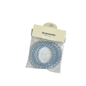 Set elastici per capelli a spirale azzurro trasparente con confezione in cartoncino