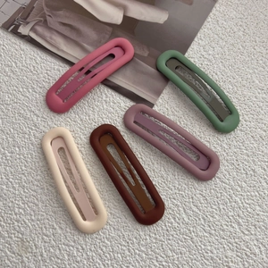 Minimalist matte hair clips in Morandi colors shown on a textured white background