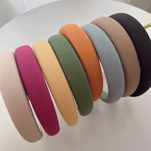 Padded sponge headbands in multiple solid colors featuring thick fabric for a high top look
