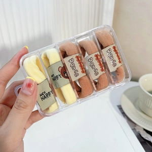 Elastici per capelli beige e arancioni con orsetti, in una scatola trasparente a 4 griglie
