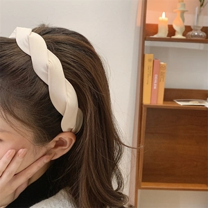 French retro cream twisted headband in satin silk fabric for an elegant hair accessory look