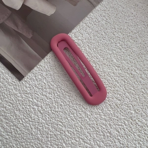 Minimalist matte rose pink metal hair clip in oval ring design with press spring mechanism