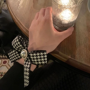 Classic houndstooth bow hair scrunchie with large pearl accent and crystal detail