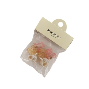 6-piece set of mini hair claw clips in pink, amber, and white on a display card