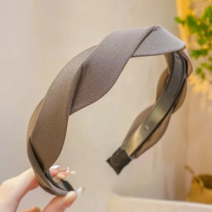 Close-up of khaki ribbed fabric texture on a vintage French twist wide headband