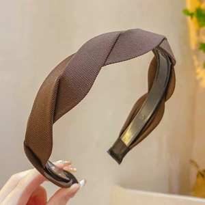 Close-up of coffee brown twisted fabric headband with ribbed texture and non-slip inner teeth