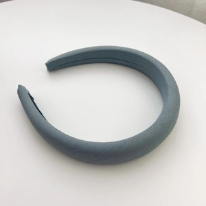 Detail of light blue knitted headband showing thick padding and black non-slip lining