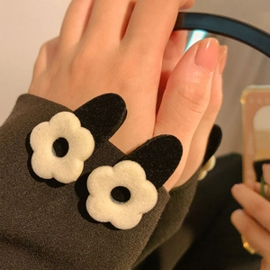 Close-up of French vintage black velvet flower hair clips with cream floral accents