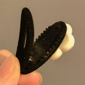 Close-up of a French vintage black velvet hair clip featuring a delicate white flower detail