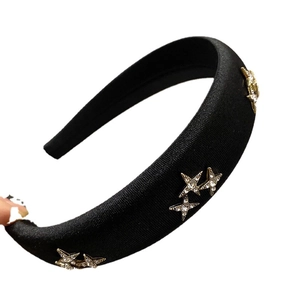 Elegant black padded sponge headband featuring golden stars with sparkling rhinestones
