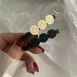 Two-piece matte hair clips set with smiley faces in black and cream beige for women