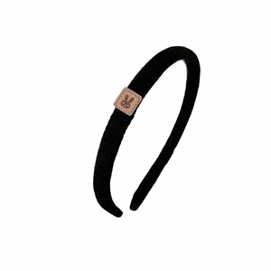Minimalist black knitted headband for women featuring a cute bunny patch detail