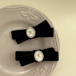 Vintage French black velvet bow hair clips with rose relief and pearl embellishments