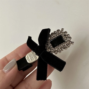 Détail de la luxueuse barrette en velours noir avec ornement en cristal carré étincelant