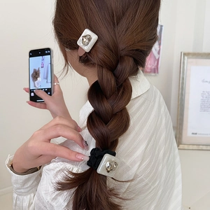 Elegant leopard heart crystal hair scrunchie and hair clip set worn by a model