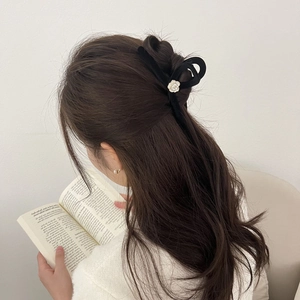 Elegant large camellia hair claw clip with black velvet and pearl accents for women