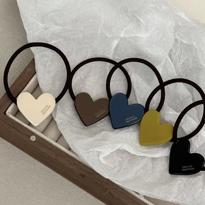 Dettaglio di cinque elastici per capelli a cuore con incisione France Handmade su vassoio