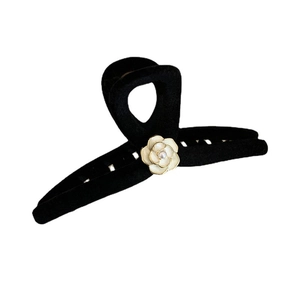 Elegant black flocked camellia hair claw clip with pearl center on white background