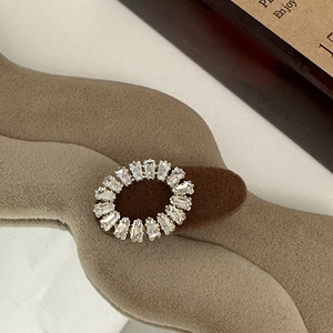 Macro view of geometric rhinestone hair clip with silver base on premium velvet