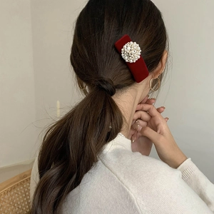 Elegant red velvet hair clip with pearls and rhinestones on woman hair