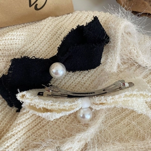Pink tweed bow hair clip with faux pearl detail and metal duckbill clip for women
